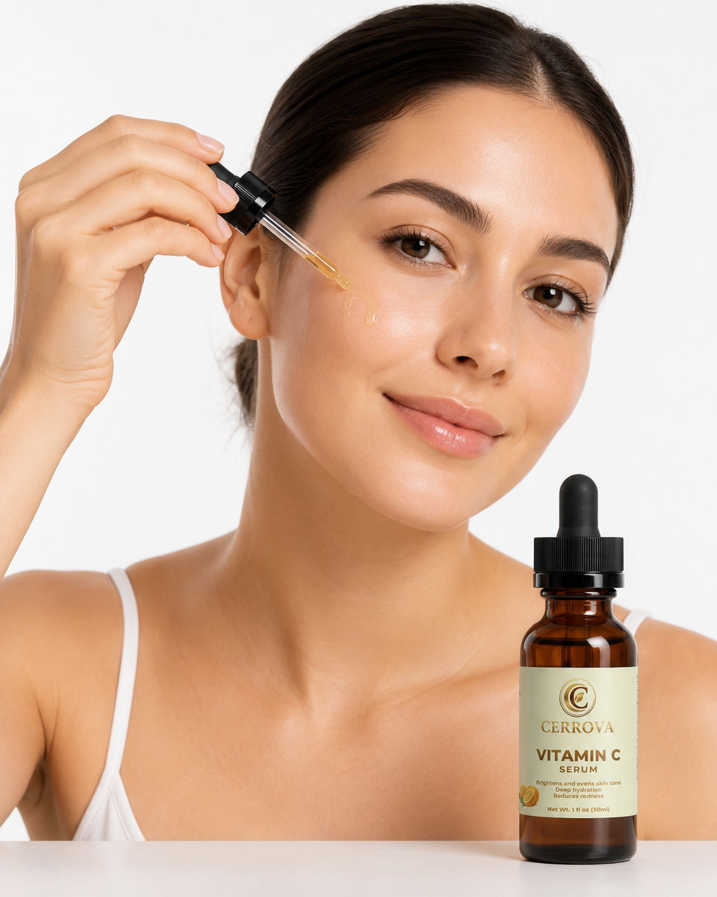 Woman applying Cerrova Vitamin C Serum to her face against a clean white background