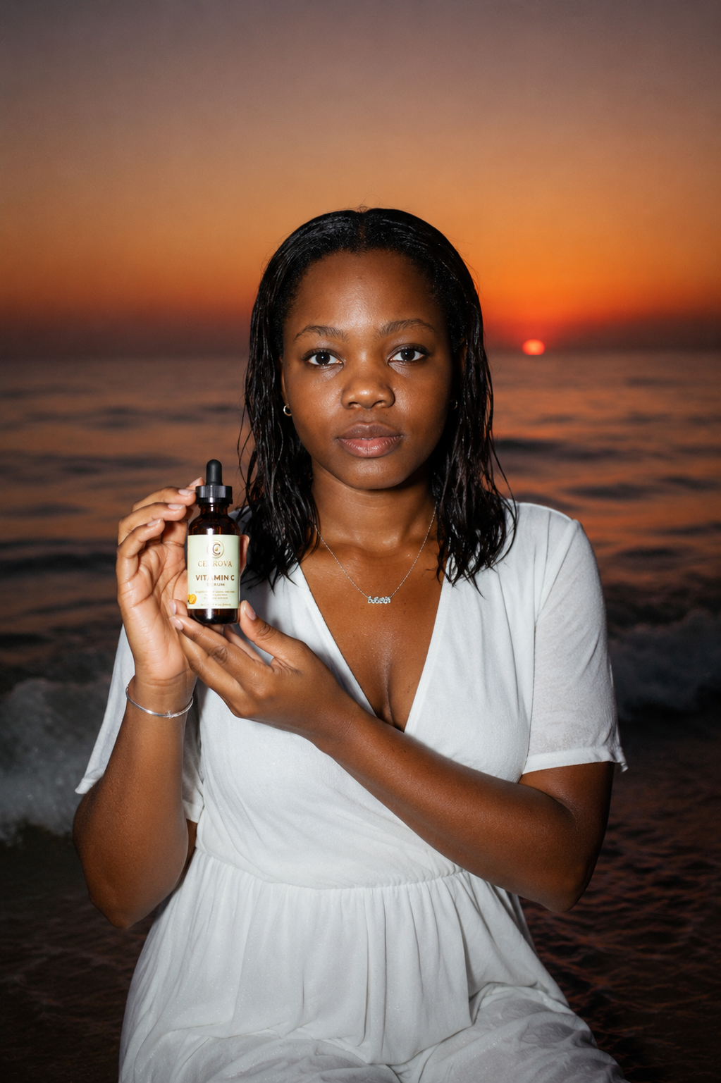Black woman holding Cerrova Vitamin C Serum on a beach at sunset, highlighting a brightening skincare routine for radiant, healthy-looking skin.